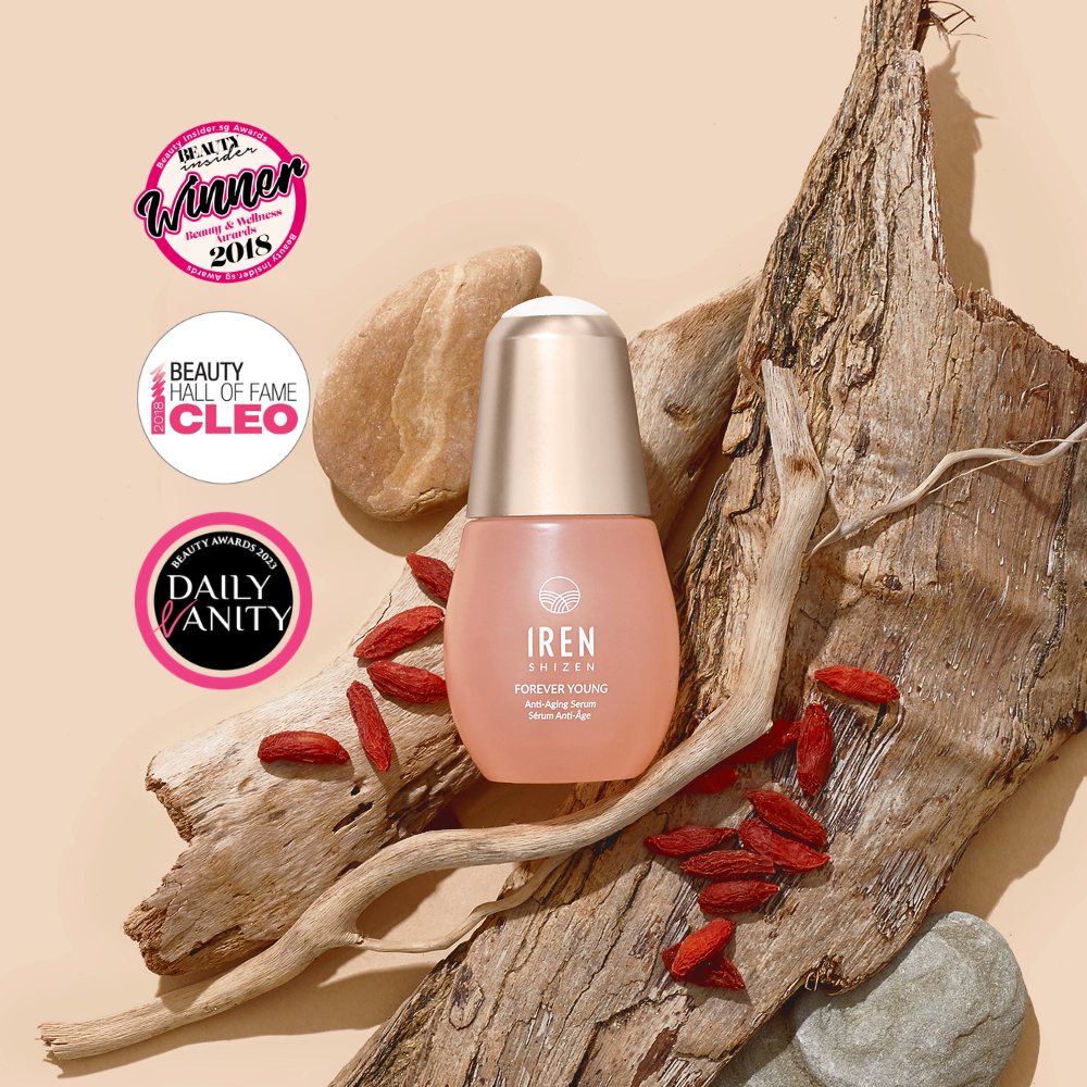 FOREVER YOUNG Anti-Aging Serum by IREN Shizen, shown on driftwood with goji berries and award badges for Best Winner 2018, Beauty Hall of Fame Cleo, and Daily Vanity—promotes anti-aging and supports collagen production.