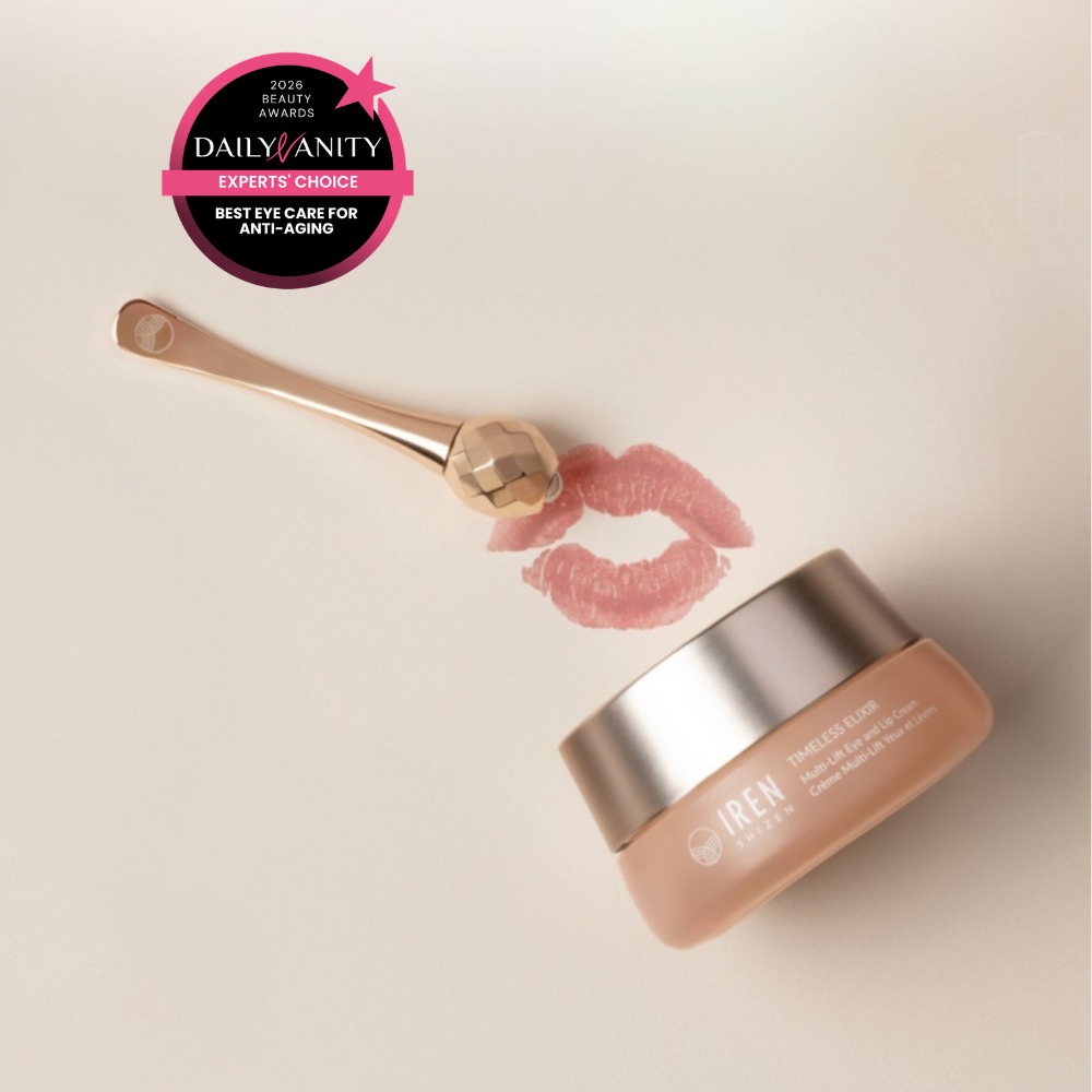 A facial roller, a jar of IREN Shizen TIMELESS ELIXIR Multi-Lift Eye and Lip Cream, a lipstick kiss mark, and a 2023 Daily Vanity Best Eye Care for Anti-Aging award badge are arranged on a light background.