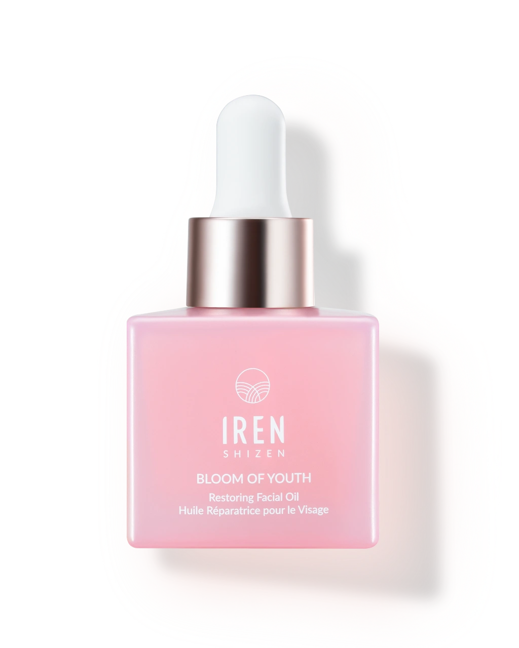 A pink glass dropper bottle of IREN Shizen BLOOM OF YOUTH Restoring Facial Oil, a lightweight oil with prebiotics and postbiotics for skin barrier repair, is displayed against a white background.