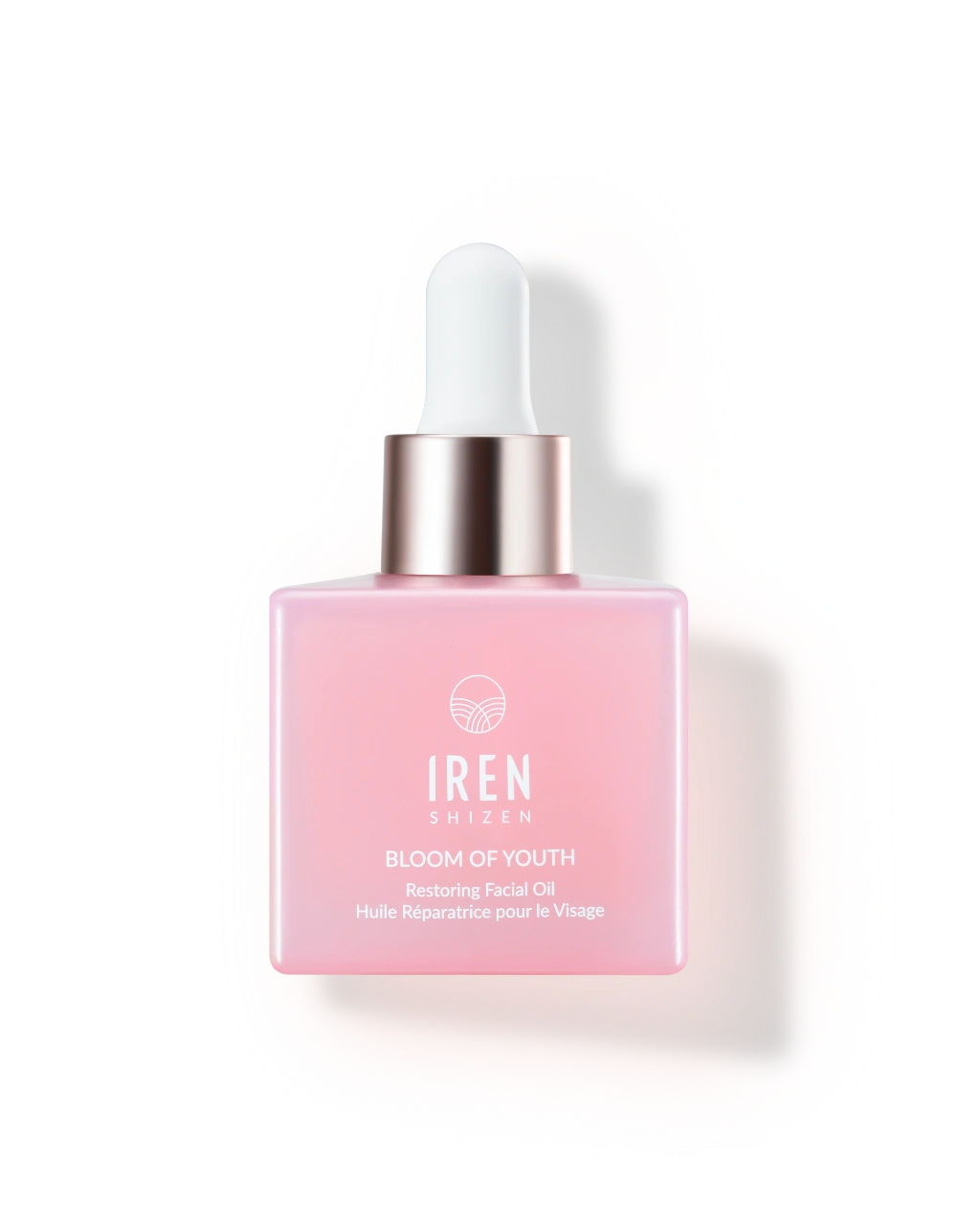 A square pink bottle of IREN Shizen BLOOM OF YOUTH Restoring Facial Oil with a white dropper cap, formulated for skin barrier repair with prebiotics and postbiotics, displayed on a plain white background.
