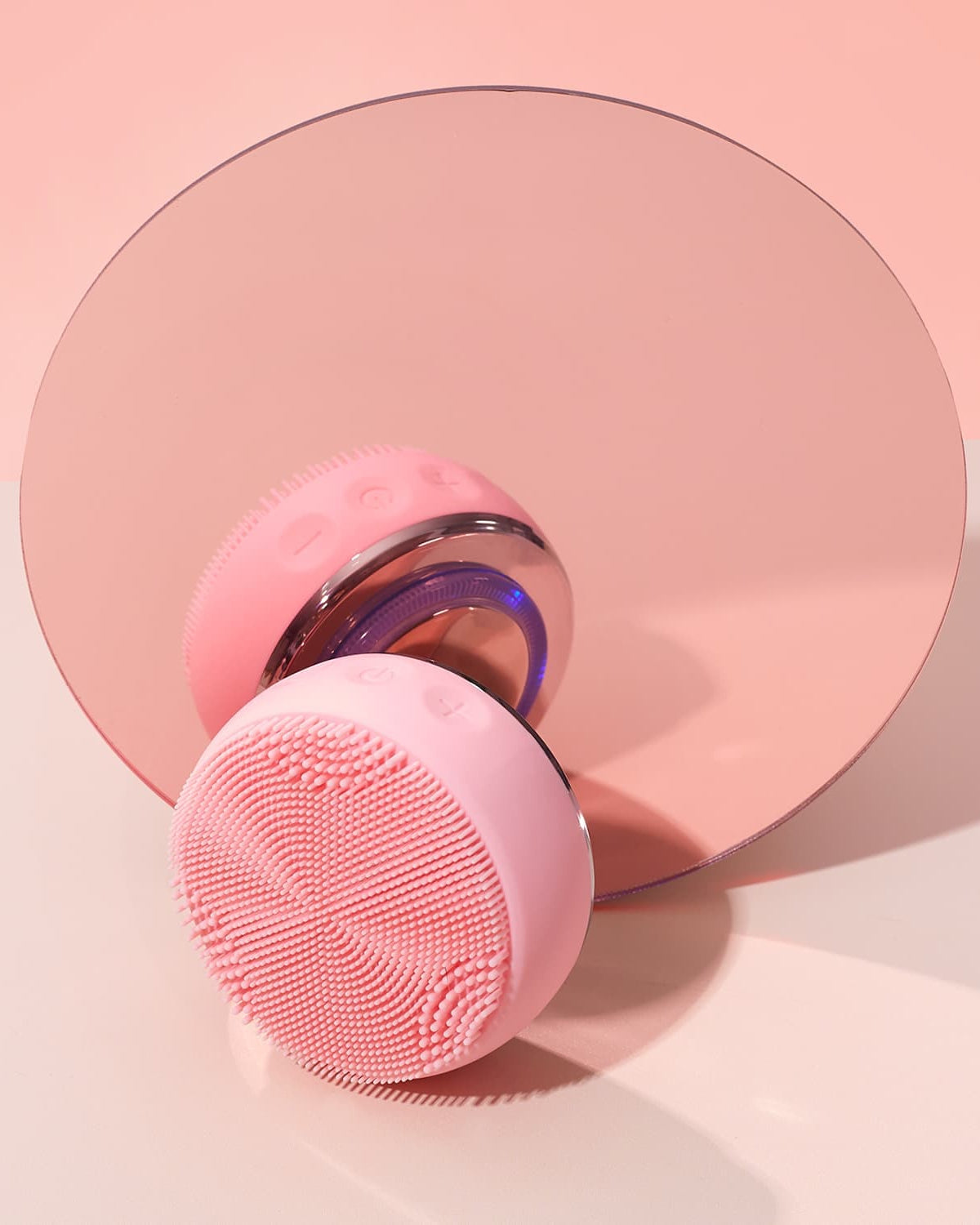 The IREN Shizen SKIN GENIE PRO Hydration Set is displayed in pink in front of a round pink mirror on a light pink and white surface.