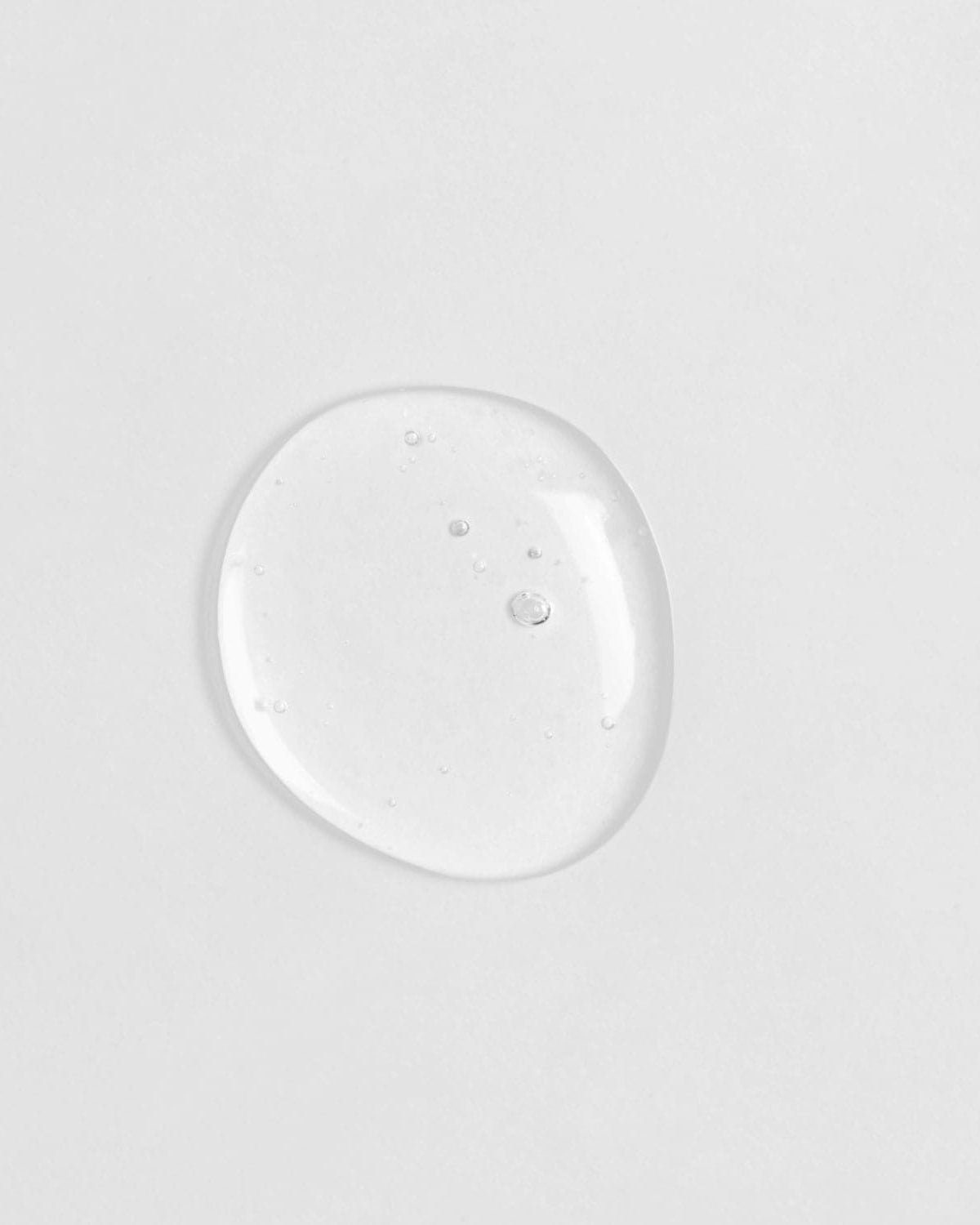 A small drop of Japanese skincare, IREN Shizen GLOW-GETTER Renewal Serum, on a white surface. #all-groups