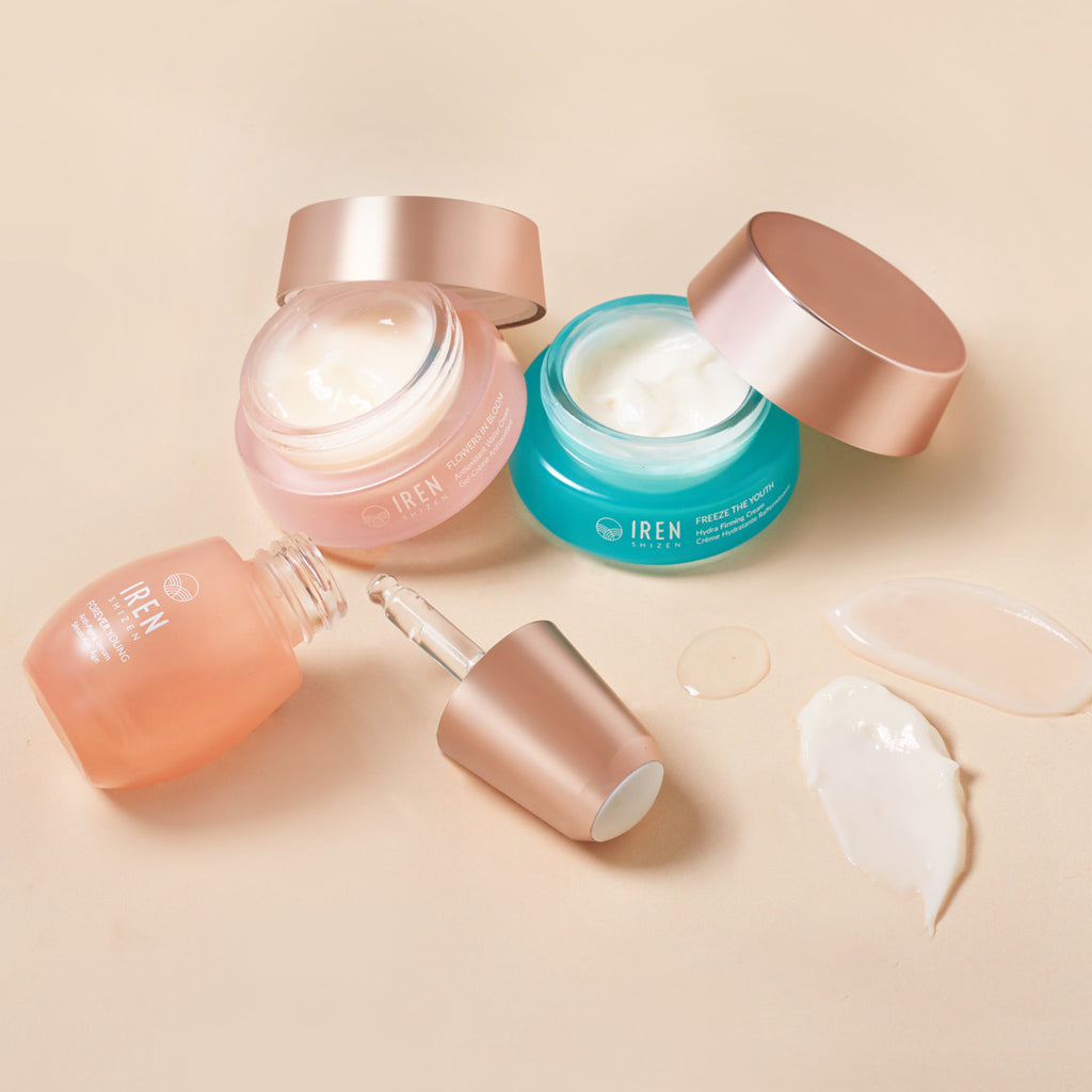 Assorted MOCHI SKIN Instant Glow Set including creams and a serum with open lids, displayed on a soft beige background.