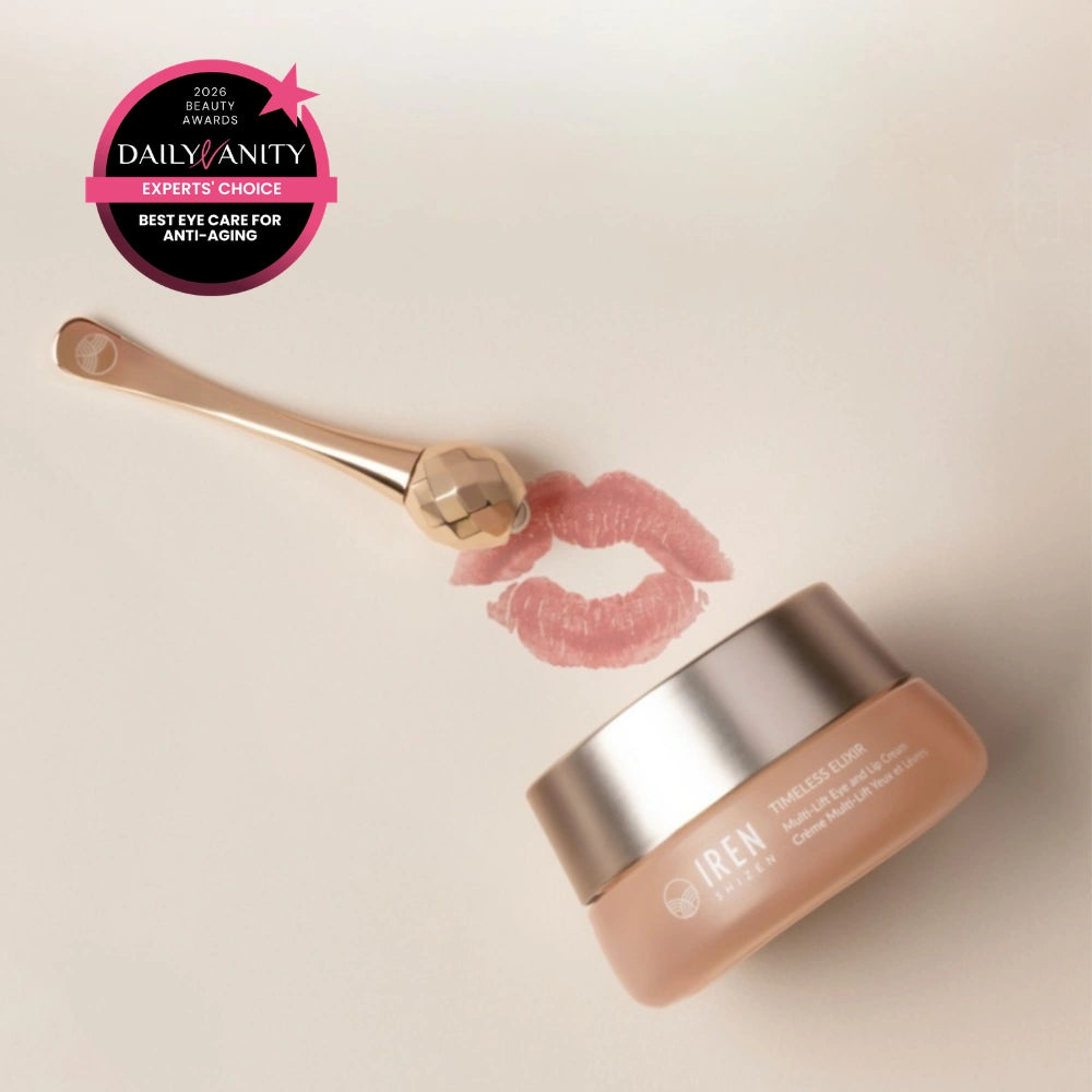 A jar of IREN Shizen TIMELESS ELIXIR Multi-Lift Eye and Lip Cream sits with a gold facial roller and lipstick print on a light surface. An award badge highlights it as "Best Eye Care for Anti-Aging" and a top dark circles treatment.