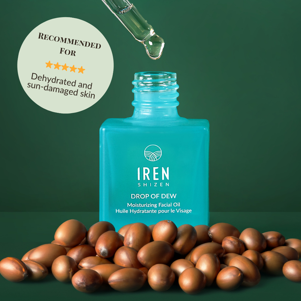 A blue bottle of IREN Shizen DROP OF DEW Moisturizing Facial Oil with a dropper above and argan nuts in front; the label highlights its recommendation for dehydrated and sun-damaged skin, supporting effective skin barrier repair.
#show-lang-en
