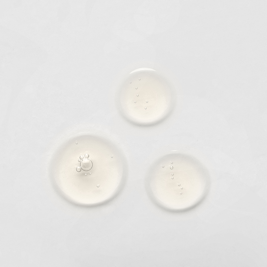 Three drops of the BEST SELLERS SET By IREN Shizen, featuring custom skincare and Japanese skincare, on a white surface.