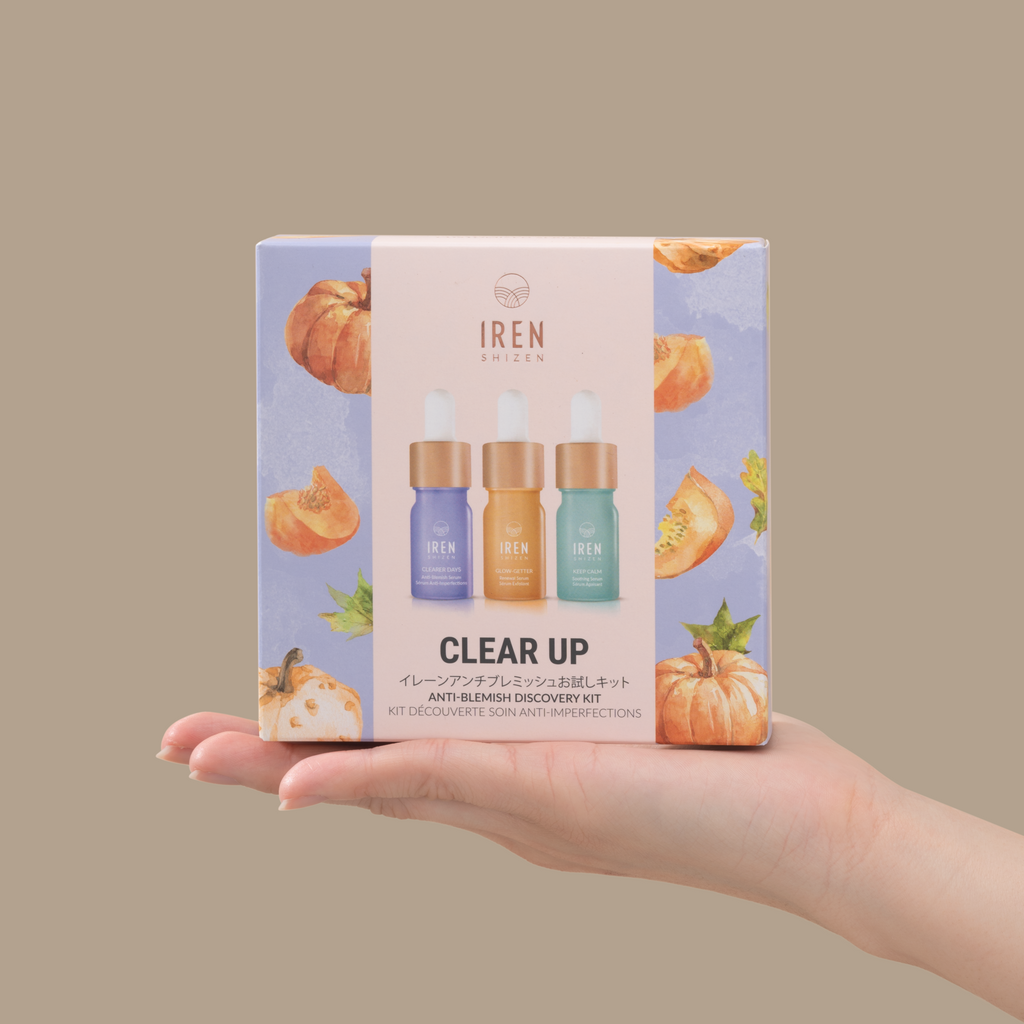 A customizable hand holding a clear PRO MINI Skin Genie Pro + Discovery Kit with pumpkins on it, perfect for a relaxing spa day.