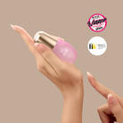 A hand holds the IREN Shizen SKIN REBOOT Antioxidant Serum with a pump, while another finger applies the pomegranate-enriched formula to help reduce dark circles; two beauty award badges appear in the background.