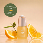 A bottle of IREN Shizen STAR LIGHT Brightening Serum is shown with orange slices and a green leaf. The label suggests it for dull, uneven skin tone and dark spots to promote a naturally radiant complexion.