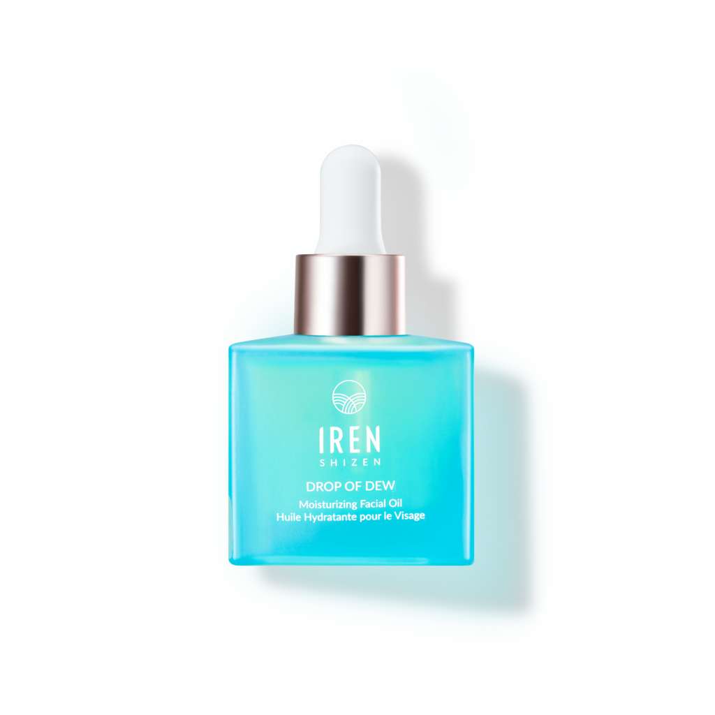 A bottle of DROP OF DEW Moisturizing Facial Oil from IREN Shizen, a Japanese skincare brand, on a black background.