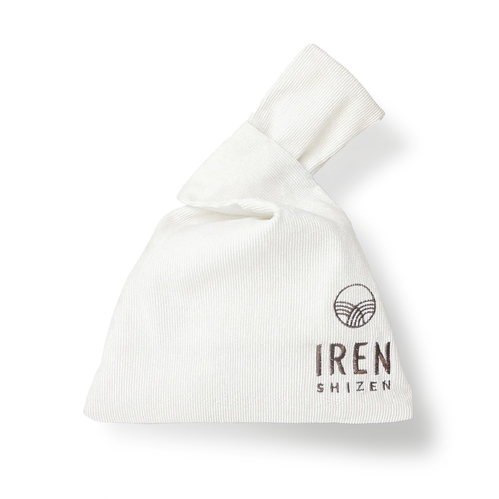 FREE GIFT Japanese Knot Bag folded on a black stand with a logo embroidered on it by IREN Shizen.