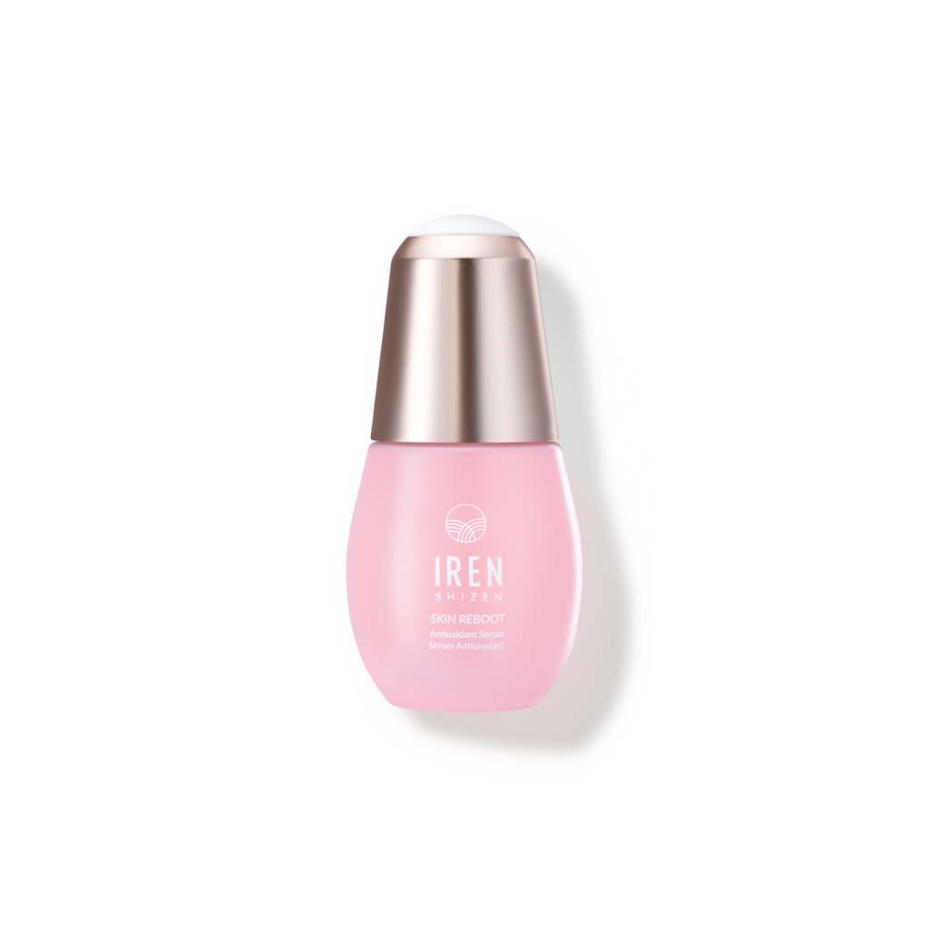 A pink SKIN REBOOT Antioxidant Serum bottle with a pink cap on a black background, by IREN Shizen, custom skincare.