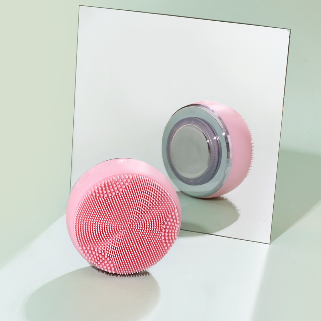 A Japanese skincare ball, part of the DEW UP PRO Skin Genie Pro + Hydrating Set, sits on top of a mirror.