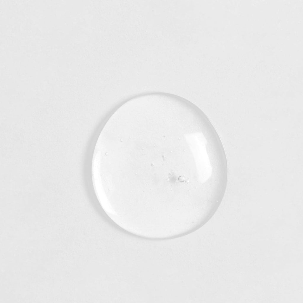 A SKIN REBOOT Antioxidant Serum by IREN Shizen, custom Japanese skincare featuring onsen-inspired formulations, captured in a clear glass ball on a white surface.