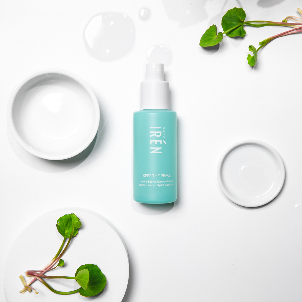 A white plate with a bottle of custom Japanese skincare - KEEP THE PEACE Hydra-Soothe Essence Lotion by IREN Shizen next to it.