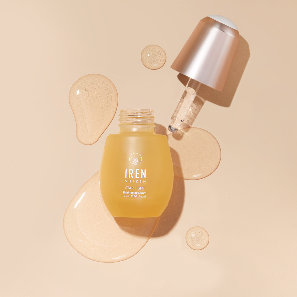A customized skincare set, including a GLOW UP PRO Skin Genie Pro + Anti-Aging Set by IREN Shizen facial oil and an onsen water bottle, showcased on a beige background.