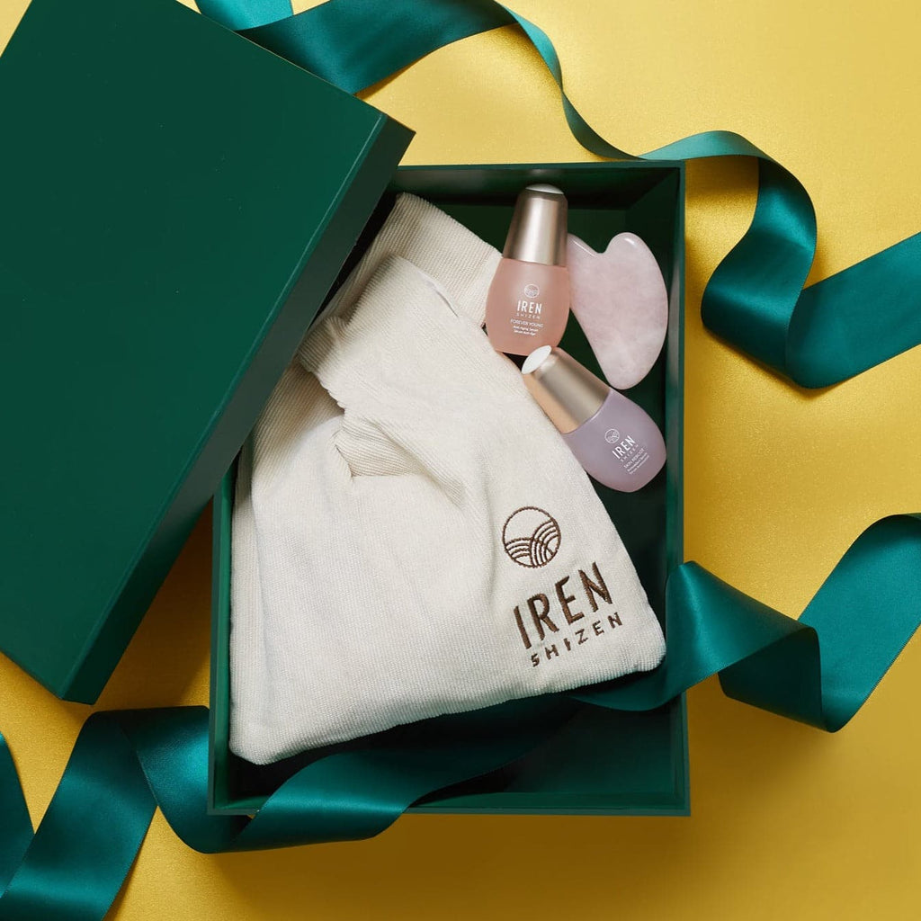 A green gift box with customized skincare products including LIFT ESSENTIAL Firm & Revitalize Set nail polish and a gift card by IREN Shizen.