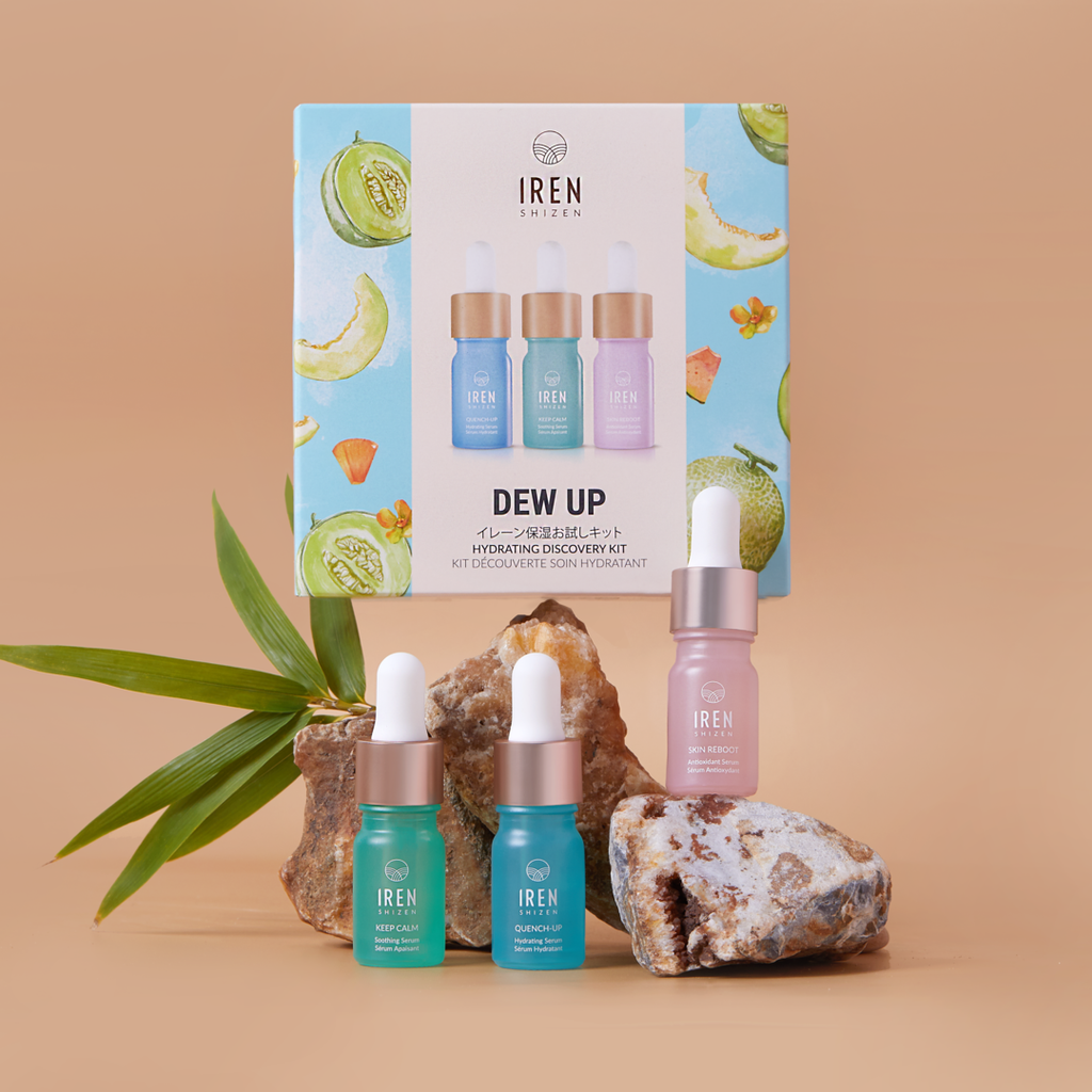 A customized Japanese skincare set, IREN Shizen DEW UP Hydrating Discovery Kits, showcased with a bottle on top of a rock.