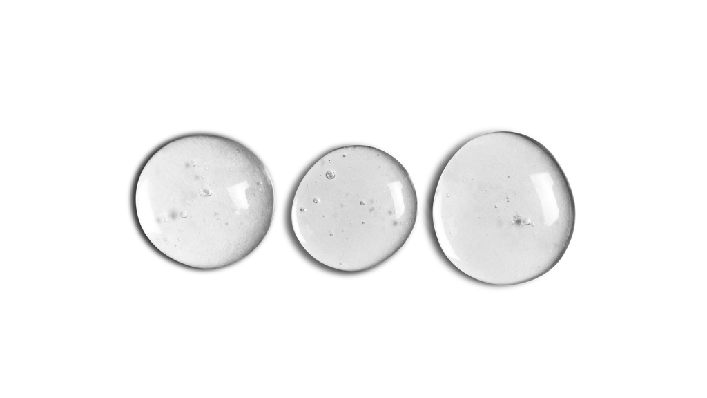 A black and white photo of three GLOW UP Facial Oil + Serums from onsen skincare on a white background.
